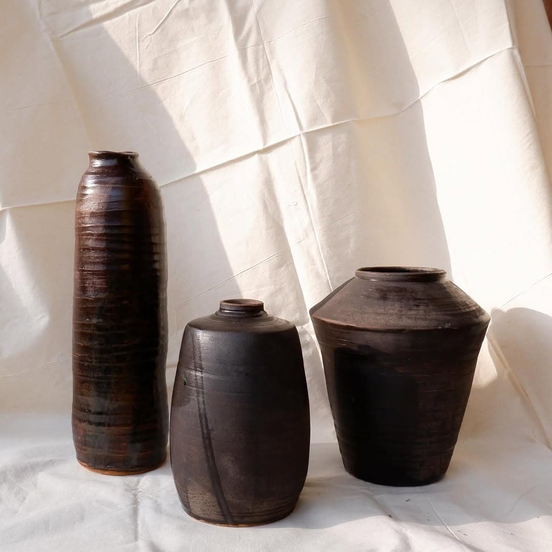 Three dark handmade ceramic vessels