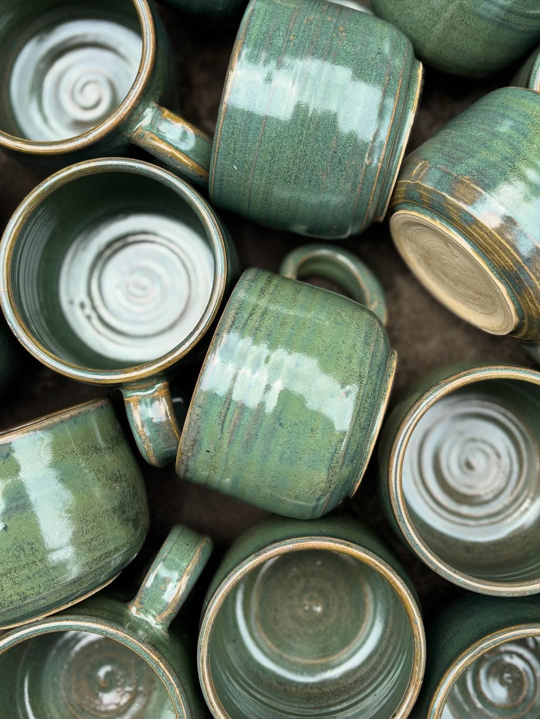 Hand-thrown Studio Sira mugs in a layered green and copper patina glaze